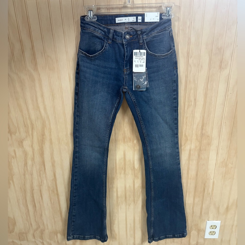 Subdued Low Rise Flare Leg Jeans